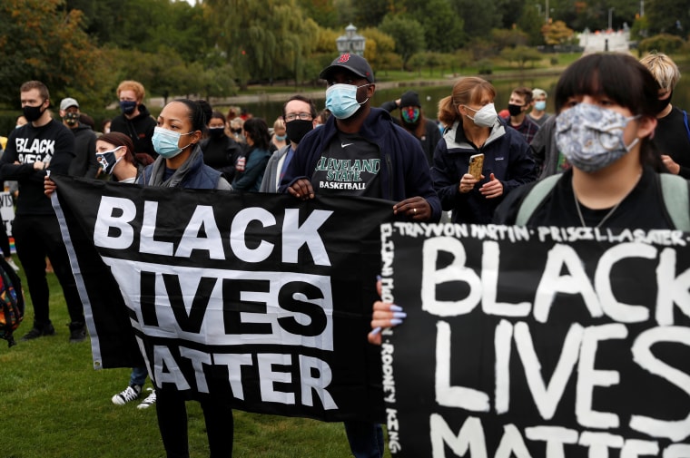 Image: Protesters hold "Black Lives Matter" banners near the venue of the first presidential debate between Joe Biden and President Donald Trump in Cleveland on Tuesday.