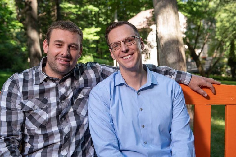 Jon Hoadley with his husband, Kris, left.