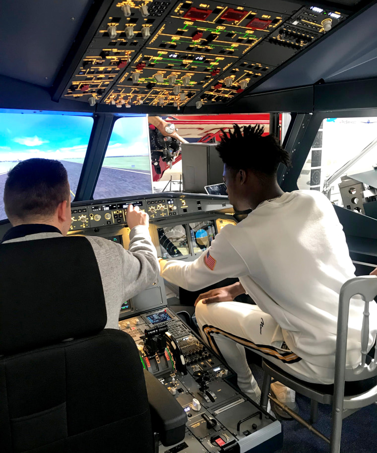 Wesley Appiah sits in an Airbus A320 cockpit. An aspiring pilot, he streams flights on Microsoft Flight Simulator.