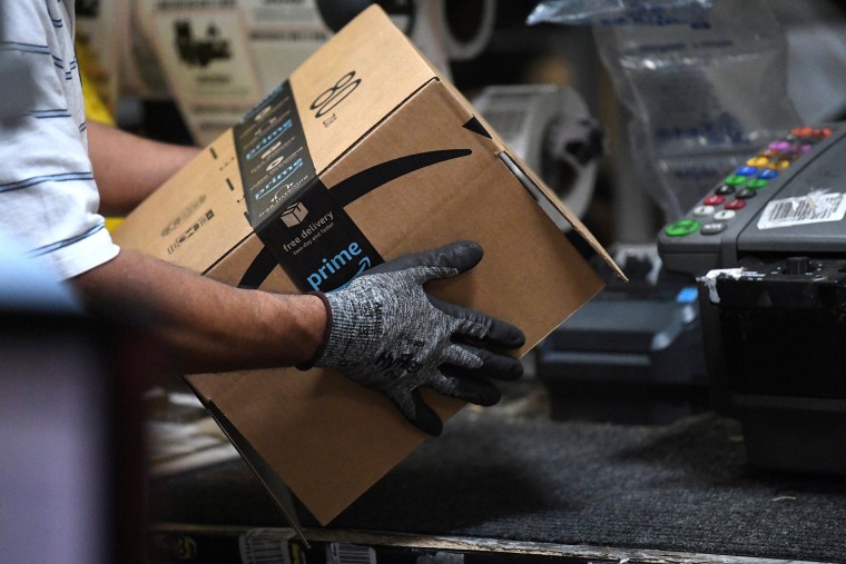 Image: Worker assembles a box for delivery at the Amazon fulfilment center in Baltimore