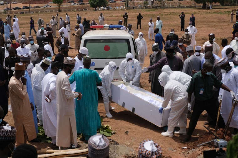 Image: Health workers prepare to bury the remains of Nigeria's Chief of Staff Abba Kyari who just died of the novel coronavirus arrived at the Gudu Cemetery where he will be buried in Abuja, Nigeria