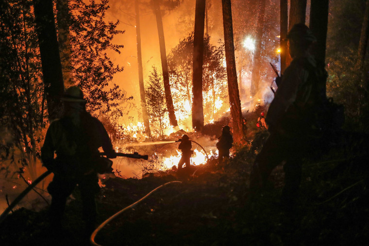 Image: Firefighters battle the Glass Fire as it encroaches towards a residence in Calistoga, California