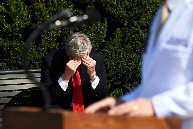 Image: White House Chief of Staff Mark Meadows rubs his head as U.S. Navy Commander Dr. Sean Conley speaks about U.S. President Donald Trump's health, in Bethesda