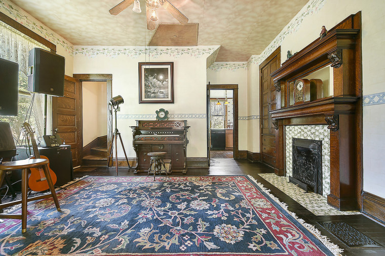 The home still has gorgeous original details like the fireplace in this room. 