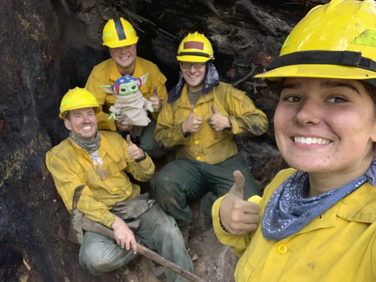 From left: Lucas Galloway, Jaebyn Drake, Rhett Schieder and Audrey Wilcox pose for a selfie with Baby Yoda on Sept. 20, 2020, while fighting the Holiday Farm Fire in Blue River, Oregon. (Courtesy of Audrey Wilcox via AP)
