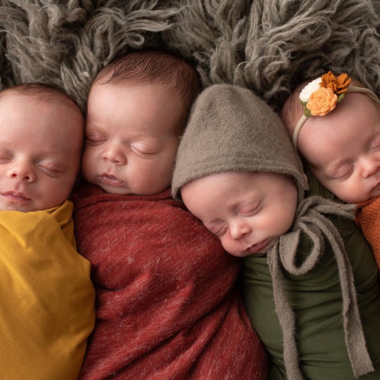 The quadruplets snuggled up for a photo.