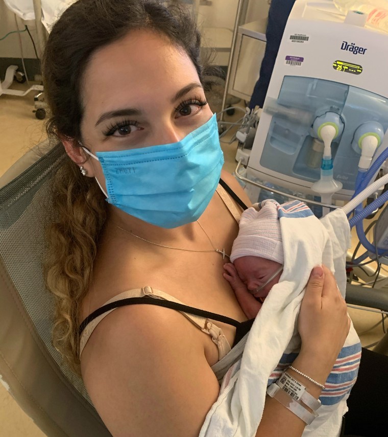 Salmonese sits with one twin in the NICU.