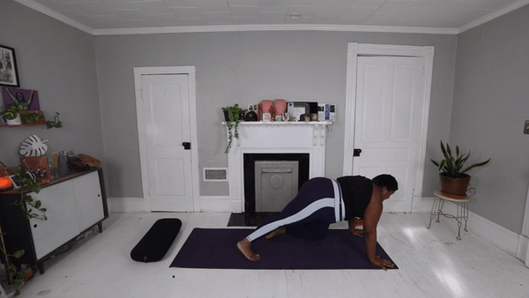 Move into caterpillar pose, also known as knees-chest-chin pose because they're all touching the ground — along with your hands and feet — in this position.