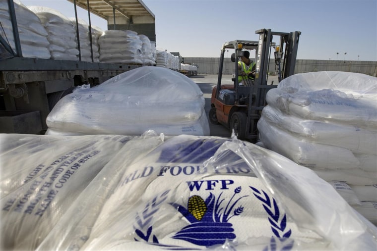 Humanitarian aid from the World Food Program to the Gaza Strip is unloaded at the Israeli side of the Rafah border crossing.