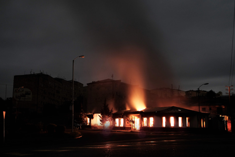 Image: A building burns after recent shelling during the ongoing fighting between Armenia and Azerbaijan over the breakaway Nagorno-Karabakh region, in the disputed region's main city of Stepanakert