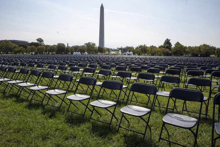 Image: Empty chairs are on display to represent the 200,000 lives lost due to Covid-19 at he National Covid-19 Remembrance on the ellipse, behind the White House