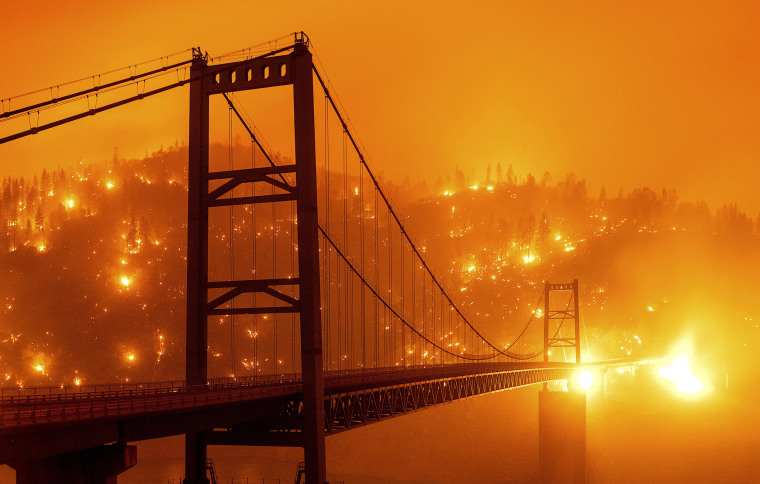 Image: Embers light up a hillside behind the Bidwell Bar Bridge as the Bear Fire burns in Oroville, Calif.