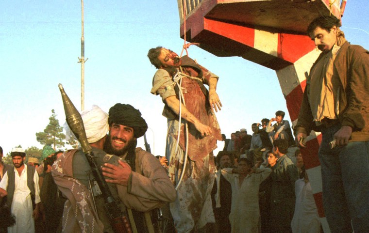 Image: Former Afghan President Najibullah's body hangs from a traffic post