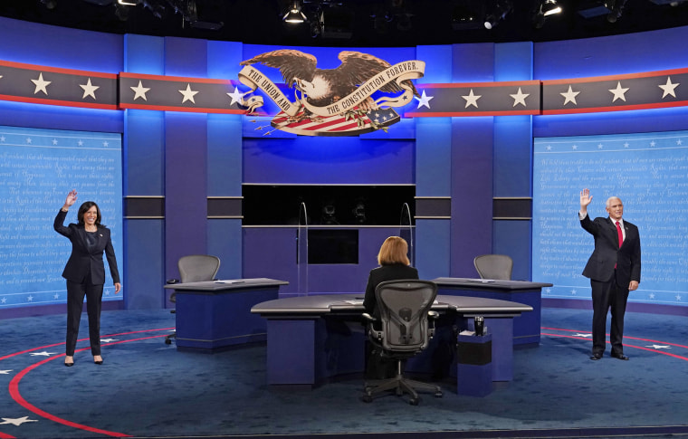 Sen. Kamala Harris and Vice President Mike Pence wave before the vice presidential debate in Salt Lake City.