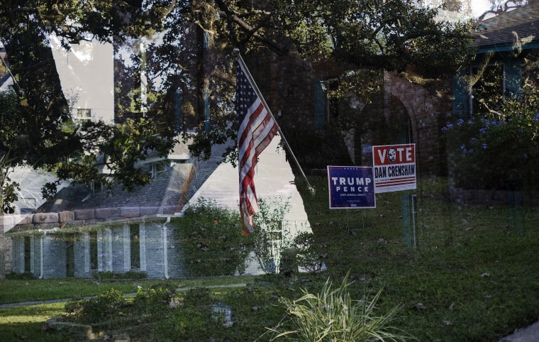 Image: Double exposure of Trump lawn signs and a house with an American flag