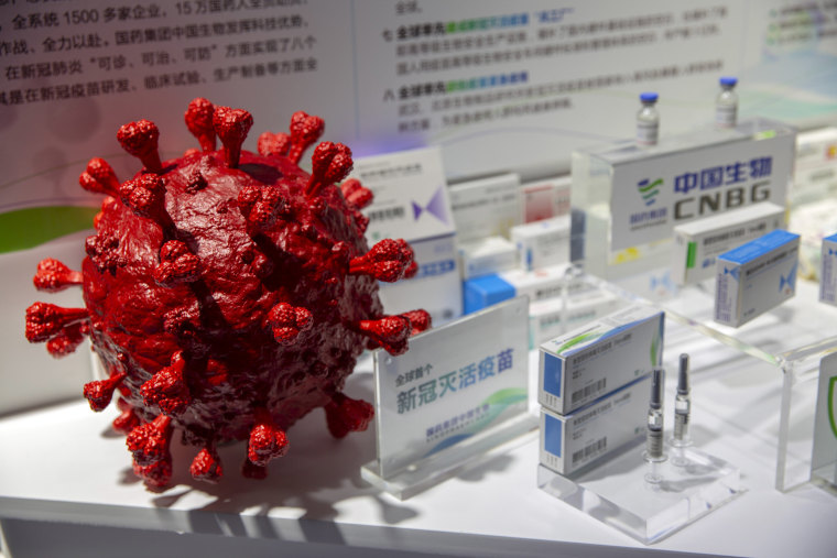Image: A model of a coronavirus is displayed next to boxes for COVID-19 vaccines at an exhibit by Chinese pharmaceutical firm Sinopharm at the China International Fair for Trade in Services (CIFTIS) in Beijing