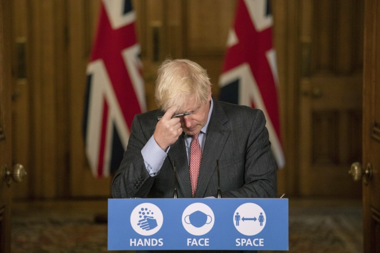 Image: Britain's Prime Minister Boris Johnson gestures, during a coronavirus briefing in Downing Street, London