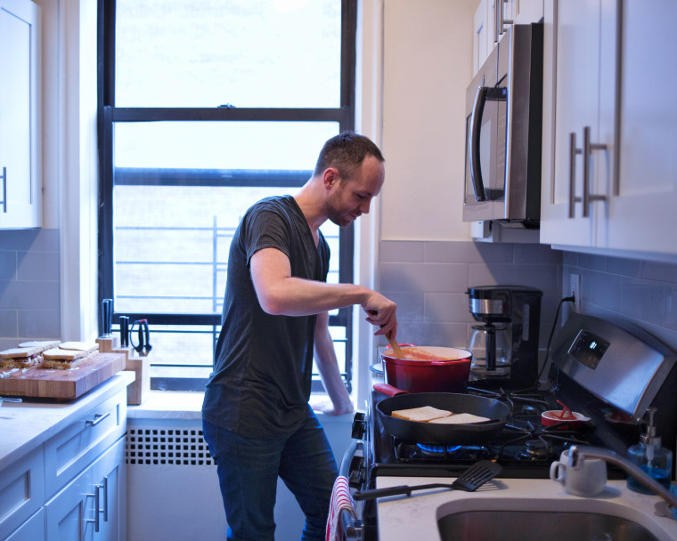 This is me, cooking some classic comfort food —  tomato soup and grilled cheese — in my Washington Heights kitchen. 