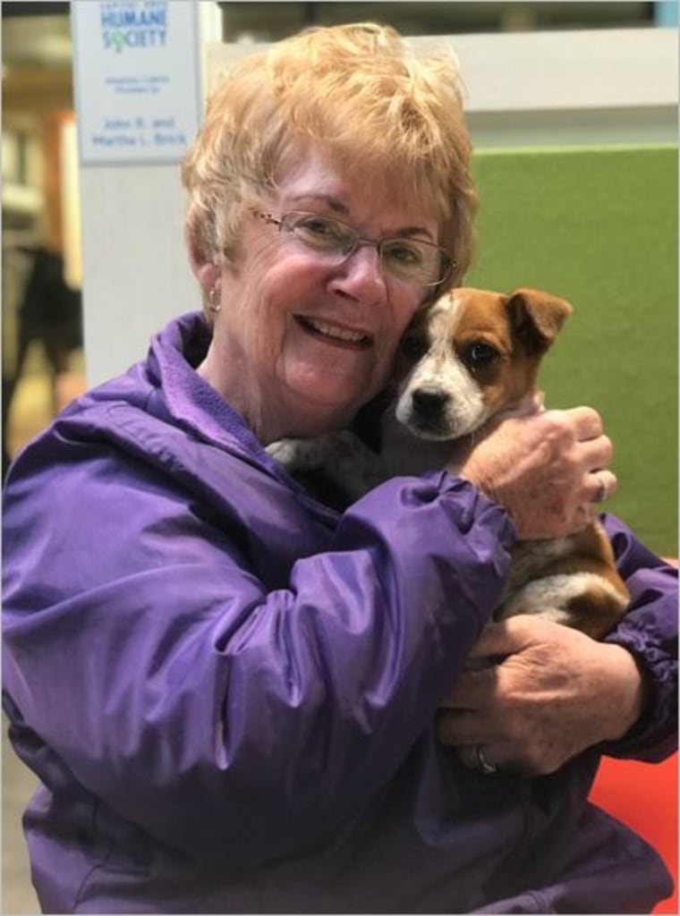 Pat Smith holds her dog, Brady.