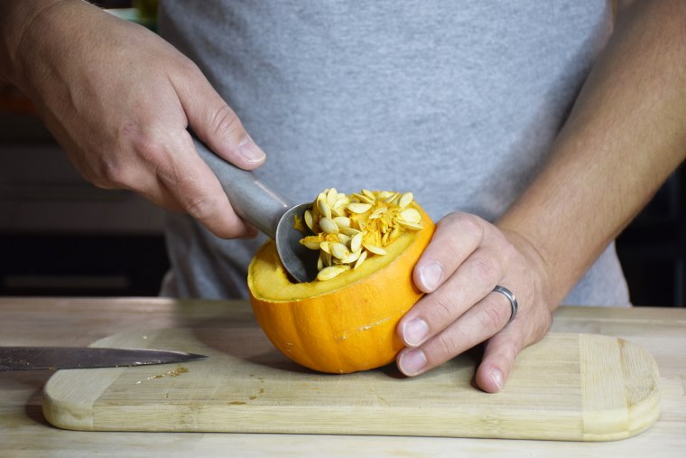 Scoop out the seeds with an ice cream scoop or large spoon.