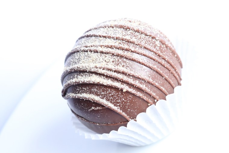 Once your pour hot milk over this s'mores hot chocolate bomb, the chocolate shell will melt to reveal mini marshmallows.
