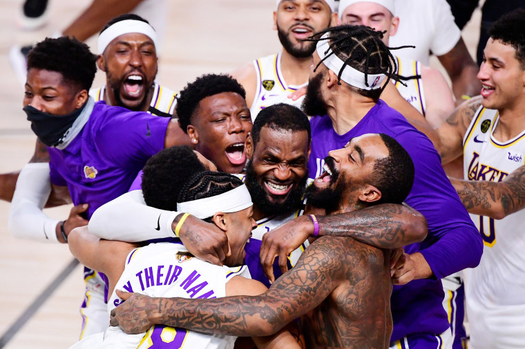 Image: LeBron James #23 of the Los Angeles Lakers celebrates with Quinn Cook #28 of the Los Angeles Lakers and teammates after winning the 2020 NBA Championship in Game Six