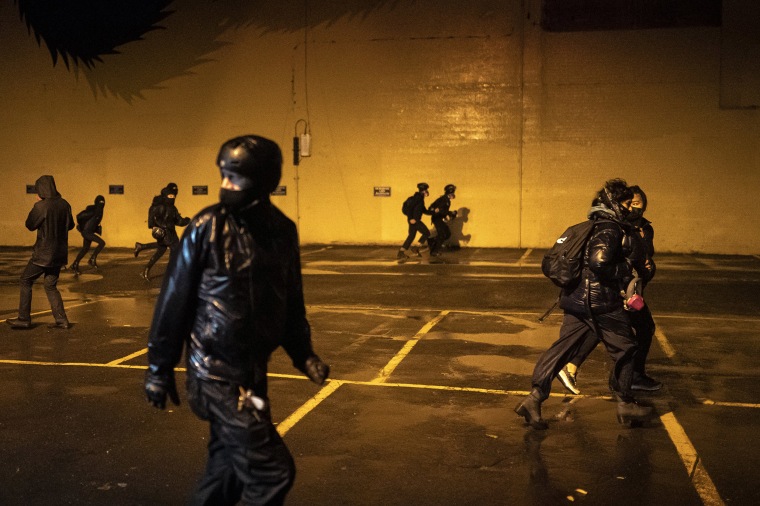 Image: Protesters flee from police during an Indigenous Peoples Day of Rage protest on Oct. 11, 2020 in Portland, Oregon.