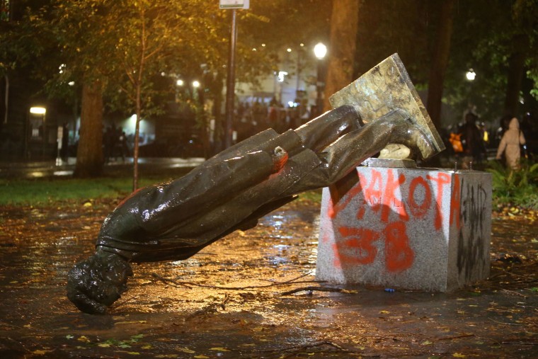 Image: A group of protesters toppled statues of former presidents Theodore Roosevelt and Abraham Lincoln in Portland's South Park Block