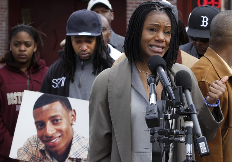 Thulani DeMarsay, aunt of Danroy "DJ" Henry Jr., who was shot and killed by a police officer, speaks as Henry's uncle Jamele Dozier holds a photograph of Henry during a news conference in Boston's Roxbury neighborhood on April 21, 2011.