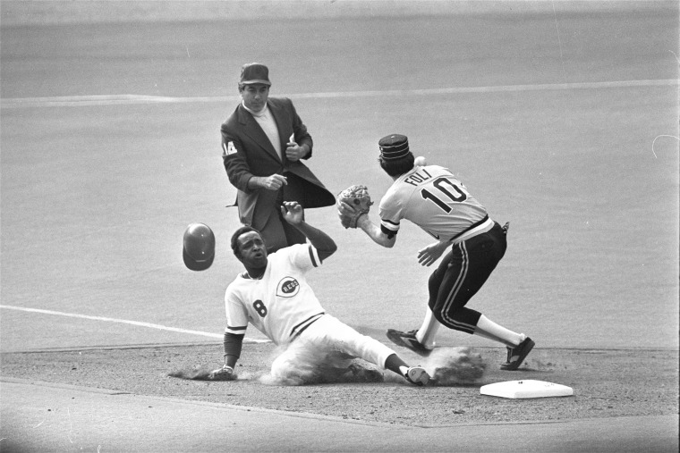Cincinnati Reds second baseman Joe Morgan slides safely into second with a steal ahead of the throw to Pirates' shortstop Tim Foli on Oct. 3, 1979.