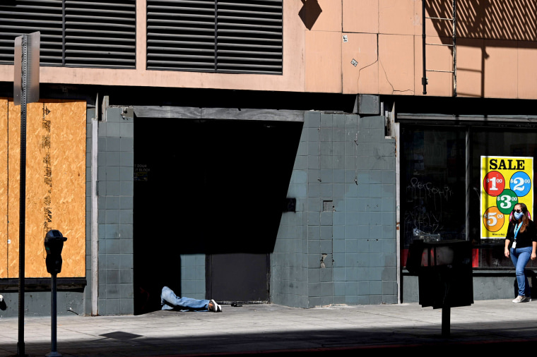 Image: A person lays in a doorway in downtown Los Angeles on Oct. 2, 2020.