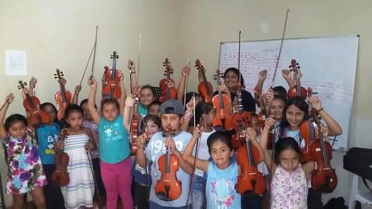 Image: Children with musical instruments donated by Mario Ar?valo