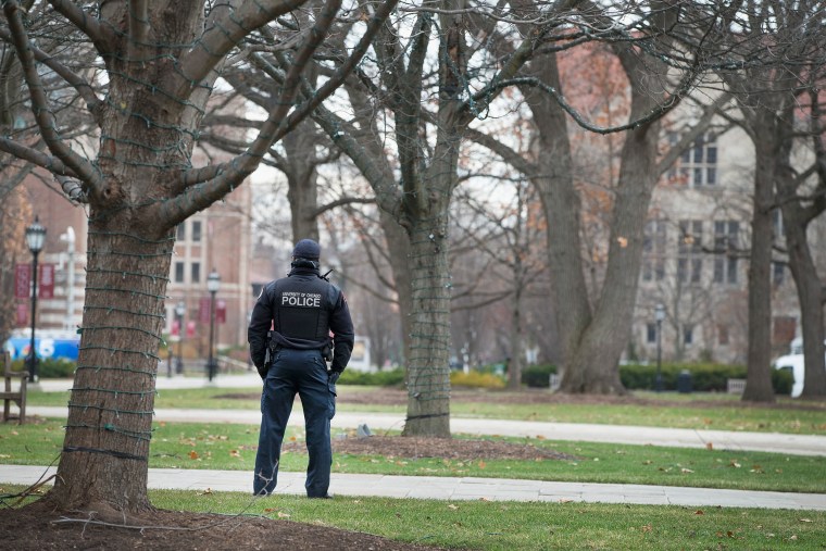 Image: A police officer stands watch in the Main Quadrangles on the Hyde Park Campus of the University of Chicago.