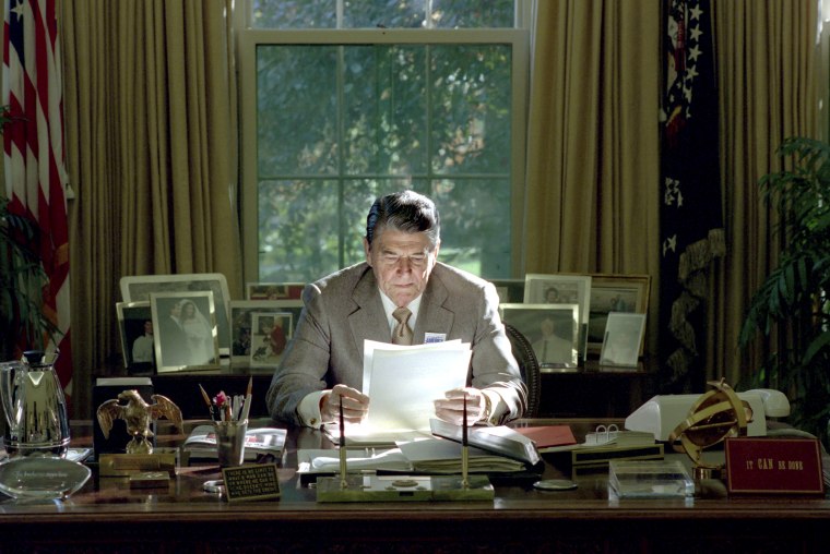 Image: President Reagan working in Oval Office, Oct. 26, 1988.