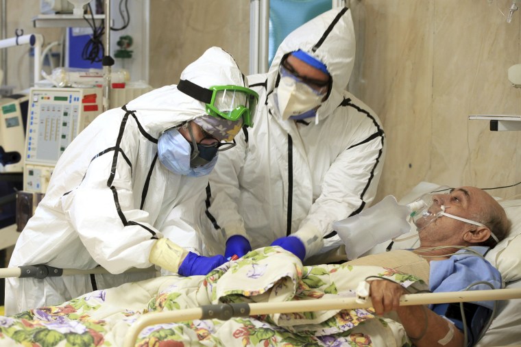 Image: A Covid-19 patient is treated at the Shohadaye Tajrish Hospital in Tehran.