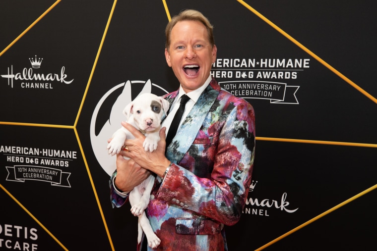 Carson Kressley holds an adoptable dog at the 2020 American Humane Hero Dog Awards.