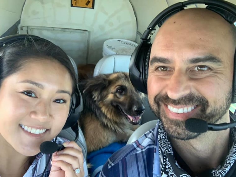 Debbie Li and Eduard Seitan smile in the cockpit during a Pilots N Paws mission.