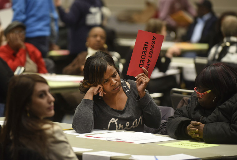 Vonettia Midgett, of Detroit, awaits assistance as the massive recounting of ballots begins for Wayne County's portion of the presidential election in Detroit on Dec. 6, 2016.