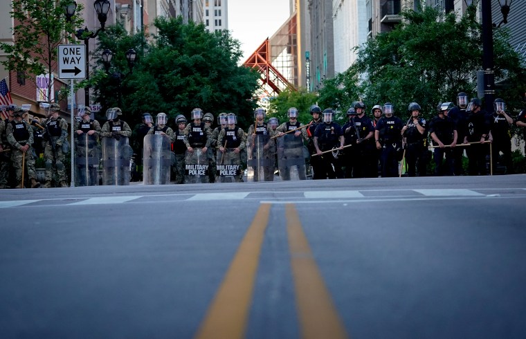 Image: National Guard soldiers stand with Louisville Metro Police to block a street during protests on May 31, 2020.