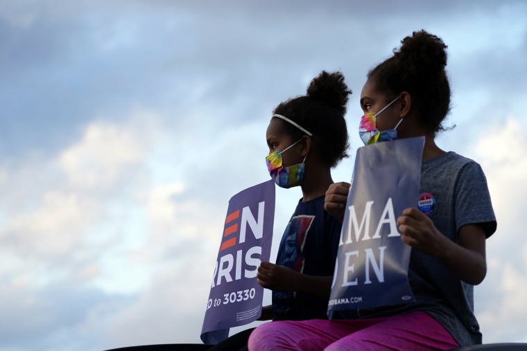 Image: Children listen as Barack Obama campaigns for Joe Biden in Philadelphia on Oct. 21, 2020.
