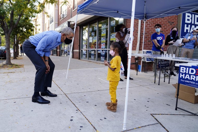 Image: Barack Obama speaks to a child outside a Democratic Voter Activation Center as he campaigns for Joe Biden in Philadelphia on Oct. 21, 2020.