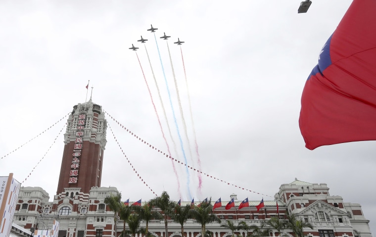 Image: Thunder Tiger Aerobatics Team fly over President Office during the National Day celebrations in Taipei, Taiwan