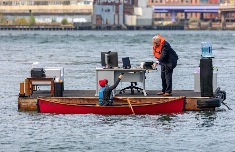 A snack boat delivers supplies to the floating office. 