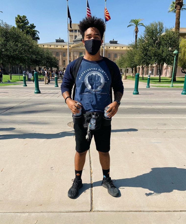 Kane Jungbluth-Murry attends a demonstration at the capitol in downtown Phoenix.