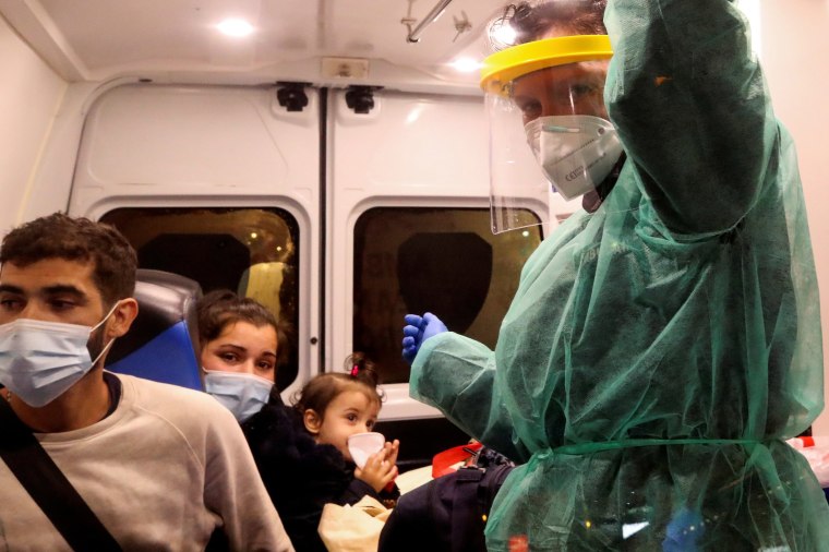 Image: A member of the medical personnel working for NAAB Ambulance wearing personal protective equipment (PPE) travels with a one-year-old in an ambulance, amid the coronavirus disease (COVID-19) outbreak, in Brussels, Belgium