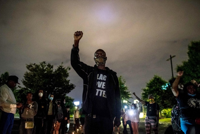 Image: Siegfried White raises his fist as he protests the fatal shooting of Rayshard Brooks, a Black man killed by a police officer, in Atlanta on June 15, 2020.