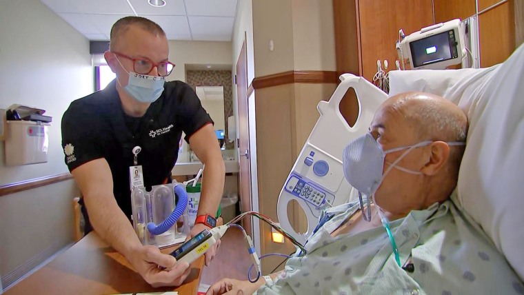 Nurse Joey Traywick with an ICU patient in Billings, Mont.