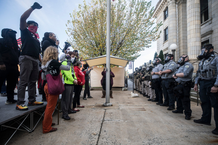 Protesters and Alamance County sheriff's deputies in riot gear face off in front of the courthouse in Graham, N.C. on Saturday. 