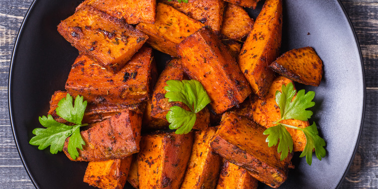 Homemade Cooked Sweet Potato with spices and herbs on dark background.; Shutterstock ID 348783449; Purchase Order: -; Segment/Job: -; Client/Licensee: -
