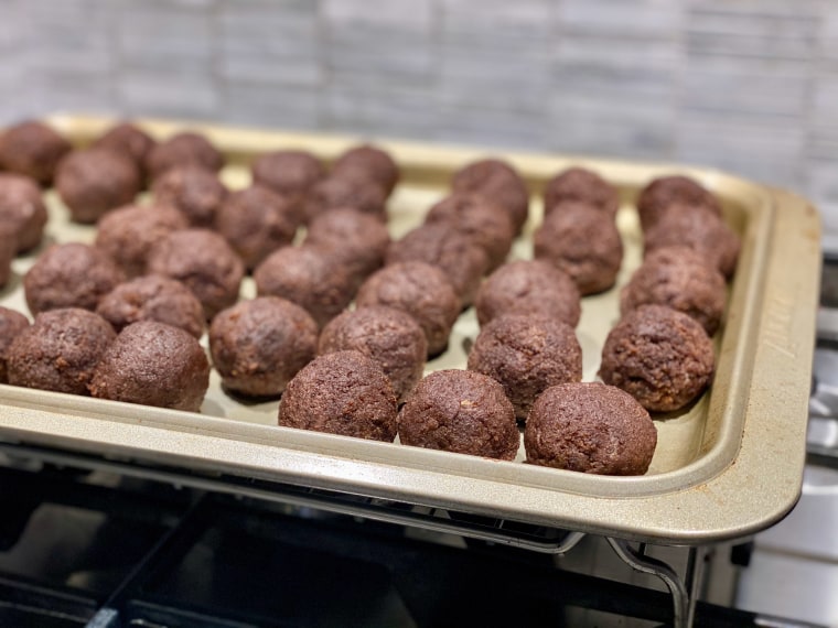 Roll the cake mixture into balls and put them on a parchment-lined sheet tray.